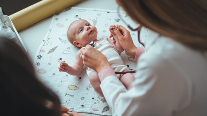 Doctor pediatrician and baby patient. Medical checkup. Doctor pediatrician examining little baby...