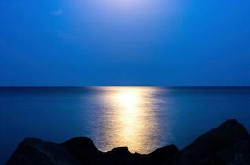 reflection of moonlight on the sea surface at night
