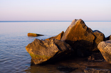 coastal stones on the sea beach at dawn
