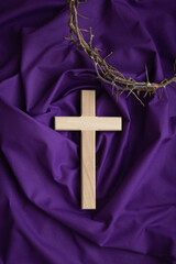 Cross and crown of thorns on a dark purple background