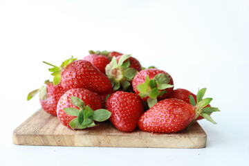  Ripe Red Strawberries on wooden board on table 