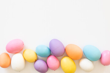 Border of Easter eggs on a white background