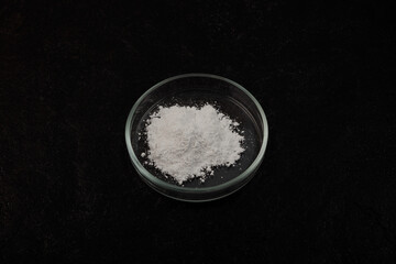 Petri dish with white chemical powder