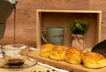 Argentinian breakfast. Croissants. Serving coffee in cup. Coffee beans. Still life. Flush plane
