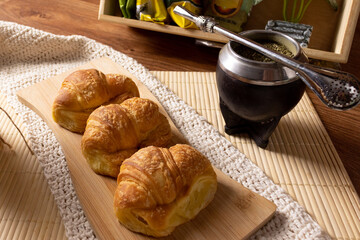 Argentinian breakfast. Croissants and mate with empty packets of yerba mate behind.