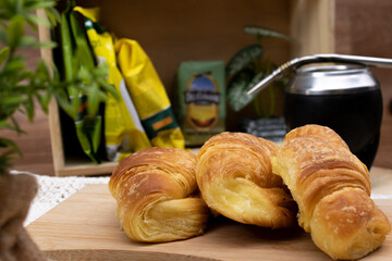 Argentinian sustainable breakfast. Croissants with mate. Decoration plant.