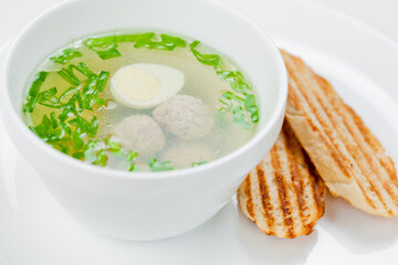 bowl of soup with meatballs