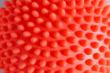 An orange massage hemisphere with spikes for training coordination and balance isolated on a white background.