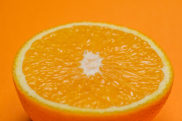 Half organic Orange on orange background 