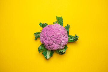 Pink cauliflower on a yellow background. Cool minimal flat lay, copy space.
