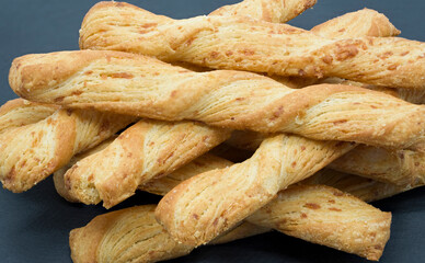 A pile of bread cheese flavoured sticks piled on top of each other