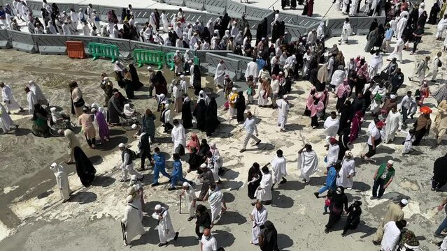 Mecca , Saudi Arabia , March 10 2023: muslim Pilgrims performing umra and walking in Al Haram Mosque - makkah city 4k video