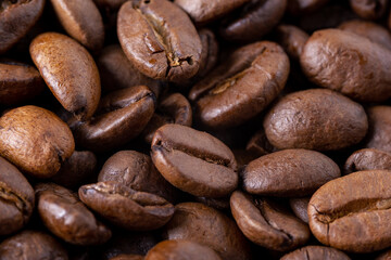 Close-up of roasted coffee beans as background. Selective focus.