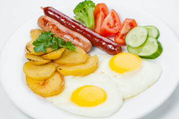 fried eggs with bacon and vegetables