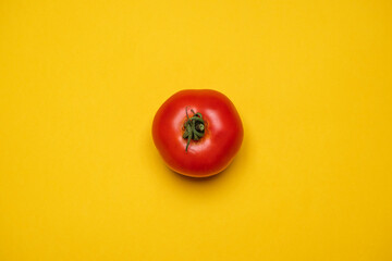 Red Tomato fresh organically grown on a yellow background. Cool minimal flat lay, copy space