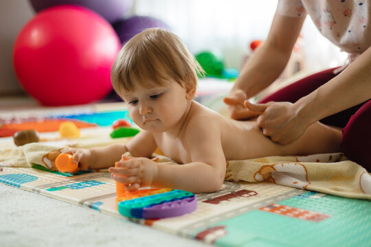 a baby whom he is massaging