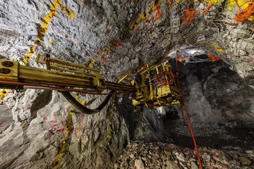 Fitting explosives into place underground at a mine in Australia