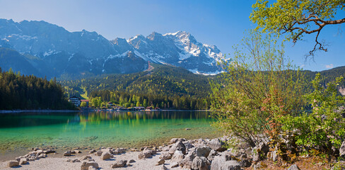 idyllic spring landscape alpine lake Eibsee and Zugspitze mountain mass, upper bavaria
