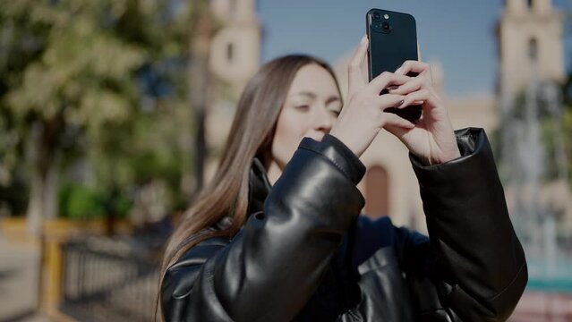 Young beautiful hispanic woman smiling confident make video by the smartphone at park