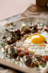fried egg with meat on pita bread
