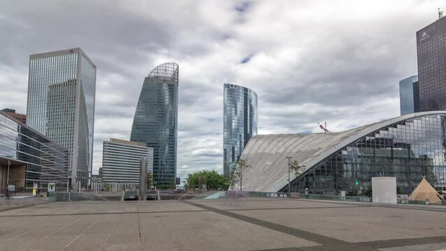 Skyscrapers of Defense timelapse hyperlapse modern business and financial district in Paris with highrise buildings and convention center. View from square. Cloudy sky and reflections in modern towers