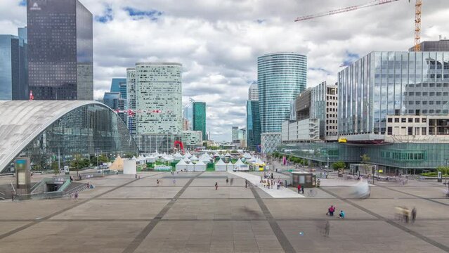 Skyscrapers of Defense timelapse hyperlapse modern business and financial district in Paris with highrise buildings and convention center. View from above. Cloudy sky in summer day