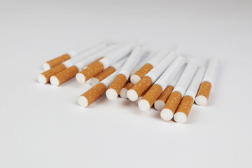 Many cigarettes on a white background. A strong passion for smoking. Harmful to health. Smoking can be harmful to your health. It's a pity for the environment. Health problem, causes cancer. Cigarette