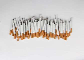 Many cigarettes on a white background. A strong passion for smoking. Harmful to health. Smoking can be harmful to your health. It's a pity for the environment. Health problem, causes cancer. Cigarette