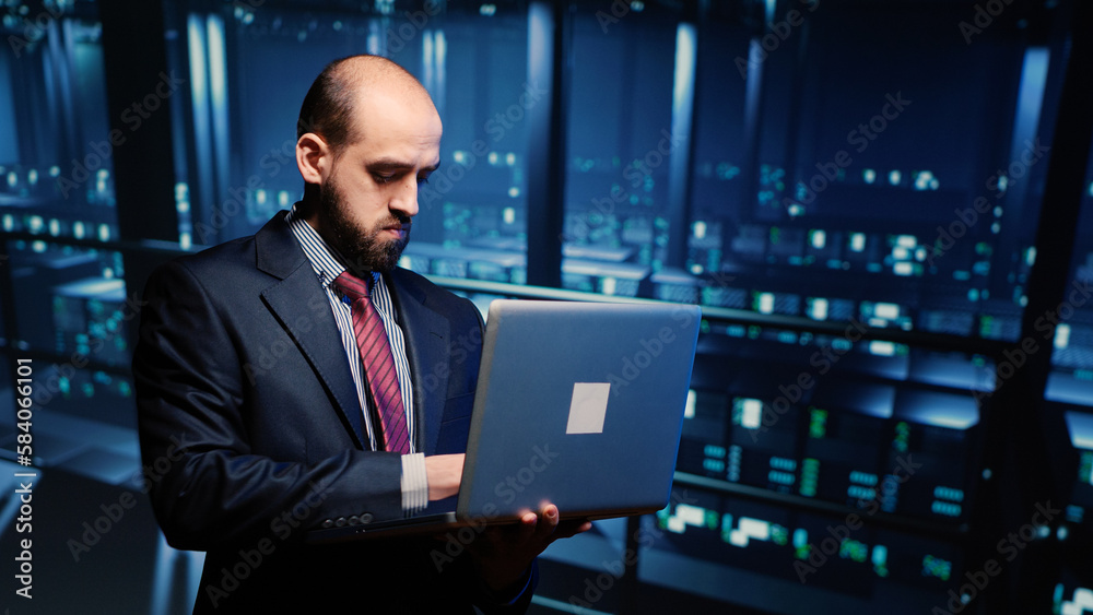Poster it server engineer inspecting working computer processor with laptop, standing in professional data 
