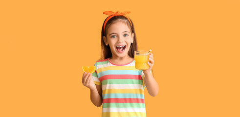 Happy little girl with orange juice on color background