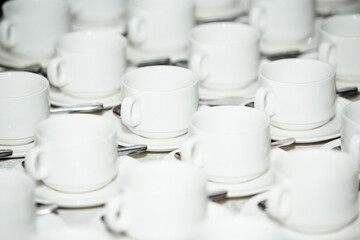 white cup and saucer on the table