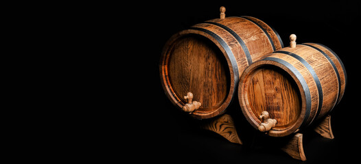 Wooden barrels on dark background with space for text