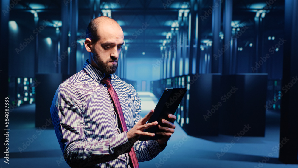Poster data center it engineer standing in server room with rack cabinets, inspecting cloud computing big d