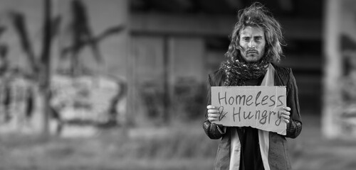 Black and white portrait of poor homeless man outdoors