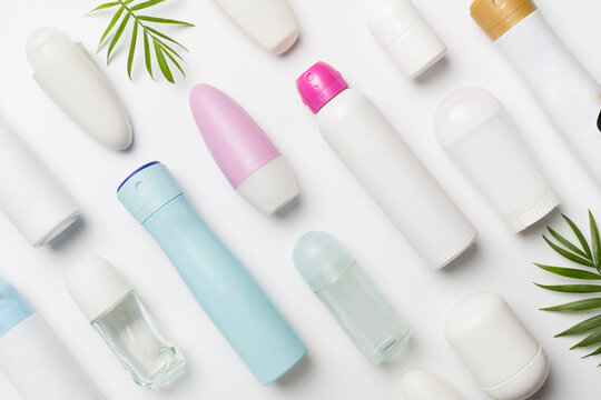 Many different deodorants on white background, top view