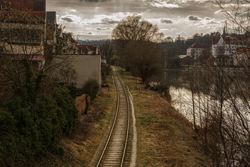 View at an old abandoned railway along the river inn at Passau city, bavaria, germany, in early spring during late afternoon