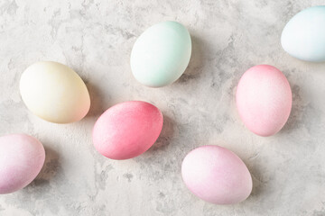 Easter eggs diagonal. Colorful pastel dyed eggs on light grey background. Flat lay,