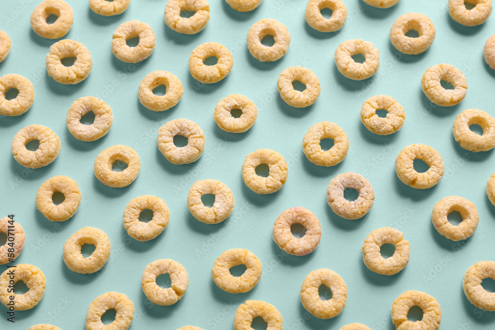 Wall mural many yellow cereal rings on blue background