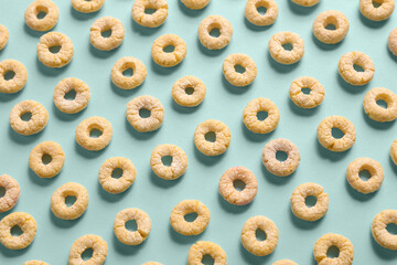 Many yellow cereal rings on blue background