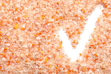 Check mark made of sea salt on white background