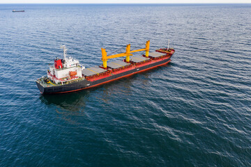 Fototapeta premium Large ship at sea. Aerial top view of cargo ship vessel import export sailing.