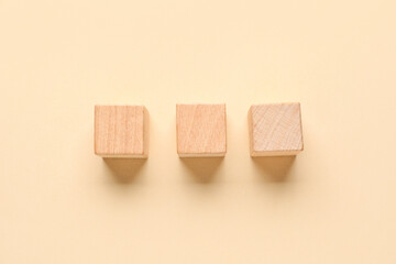 Wooden cubes with check marks on beige background