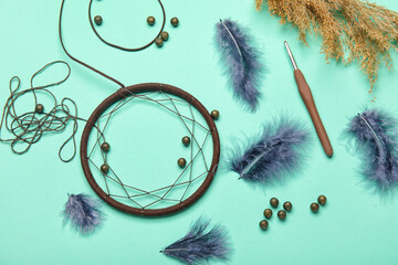 Materials for making dream catcher on green background