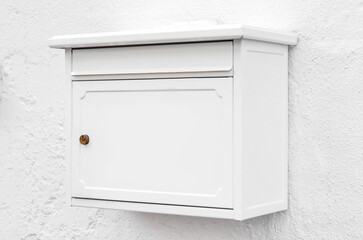 View of mailbox on white building wall