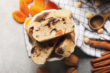 Bowl with delicious biscotti cookies on grunge background, closeup