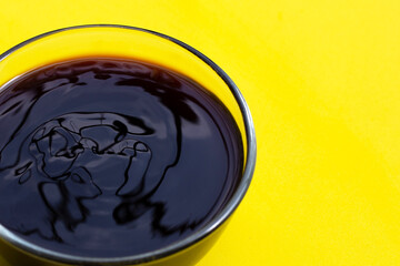 Oyster sauce on yellow background.