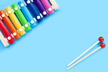 Colorful xylophone on blue background.