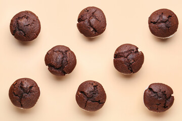 Tasty chocolate cupcakes on beige background
