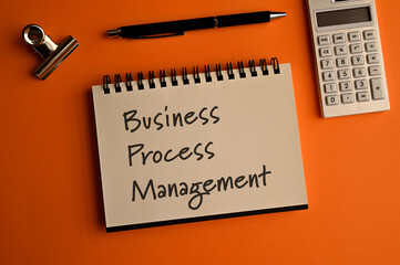 There is a notebook with the word Business Process Management. It is eye-catching image.