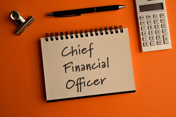 There is a notebook with the word Chief Financial Officer. It is eye-catching image.